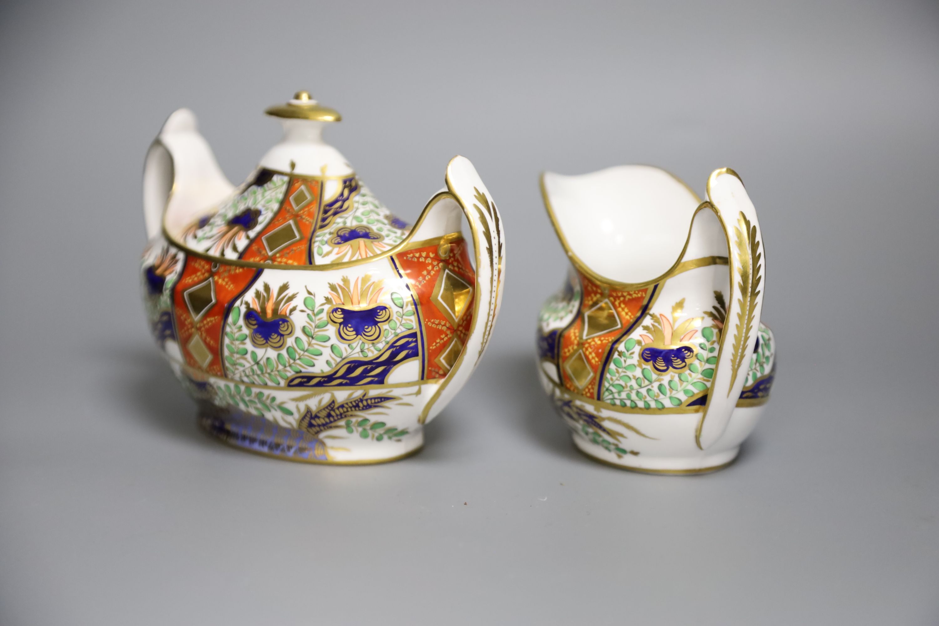 A Spode sucrier and cover painted in imari style with pattern 2213 and a matching 2213 cream jug